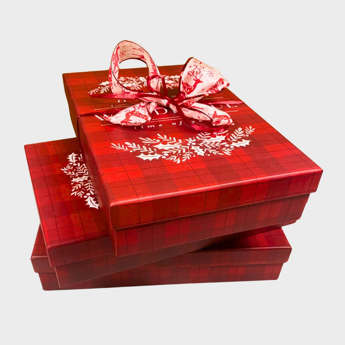 Stack of red plaid gift boxes with decorative bows on a white background