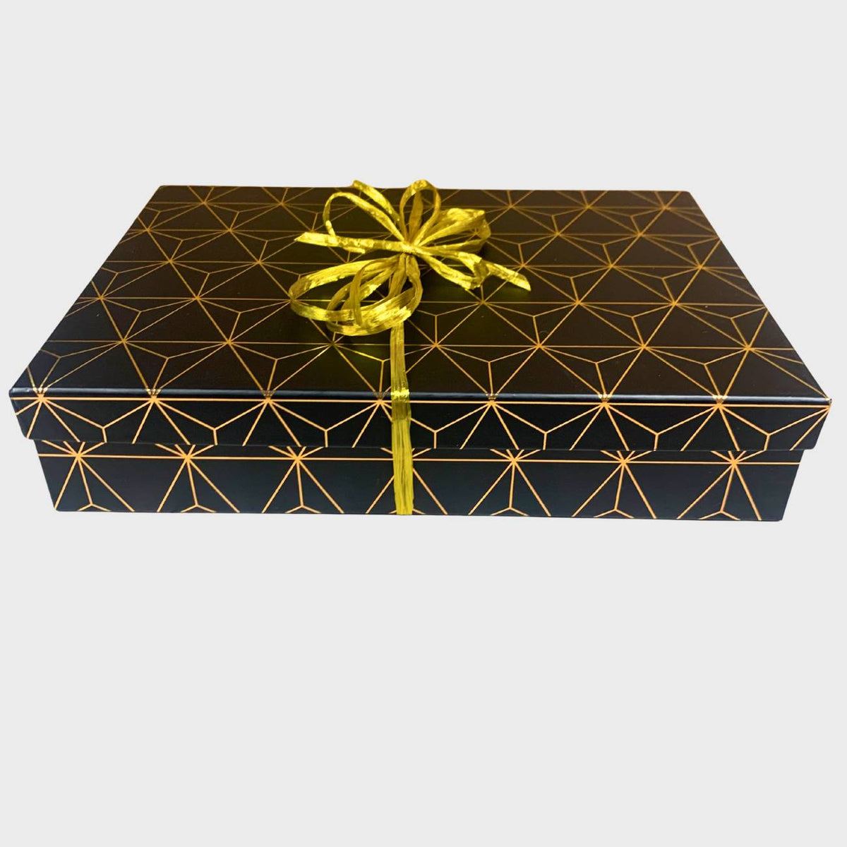 Gift box with geometric pattern and gold ribbon on a white background