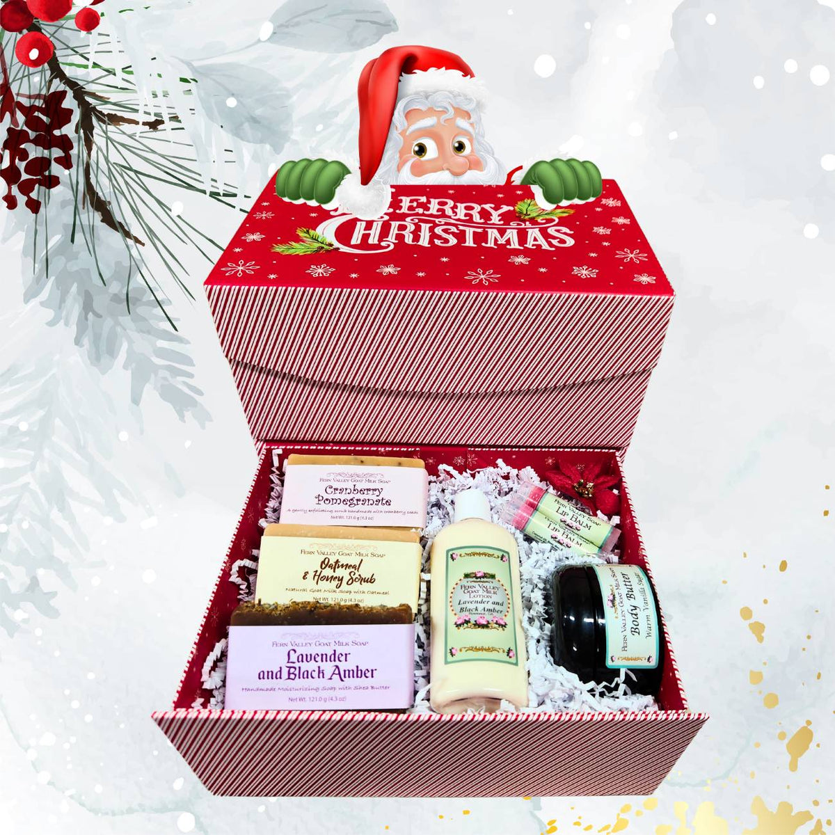 An open red and white striped Christmas gift box with a peek-a-boo Santa Claus lid design, neatly filled with white crinkle paper, three Fern Valley goat milk soap bars (Cranberry Pomegranate, Oatmeal & Honey, Lavender and Black Amber), a bottle of lotion, a jar of body butter, and two lip balms.