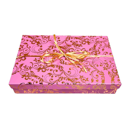  A closed luxury rectangular holiday gift box elegantly tied with a matching satin bow and holiday ribbon overlay, presented on a clean background.