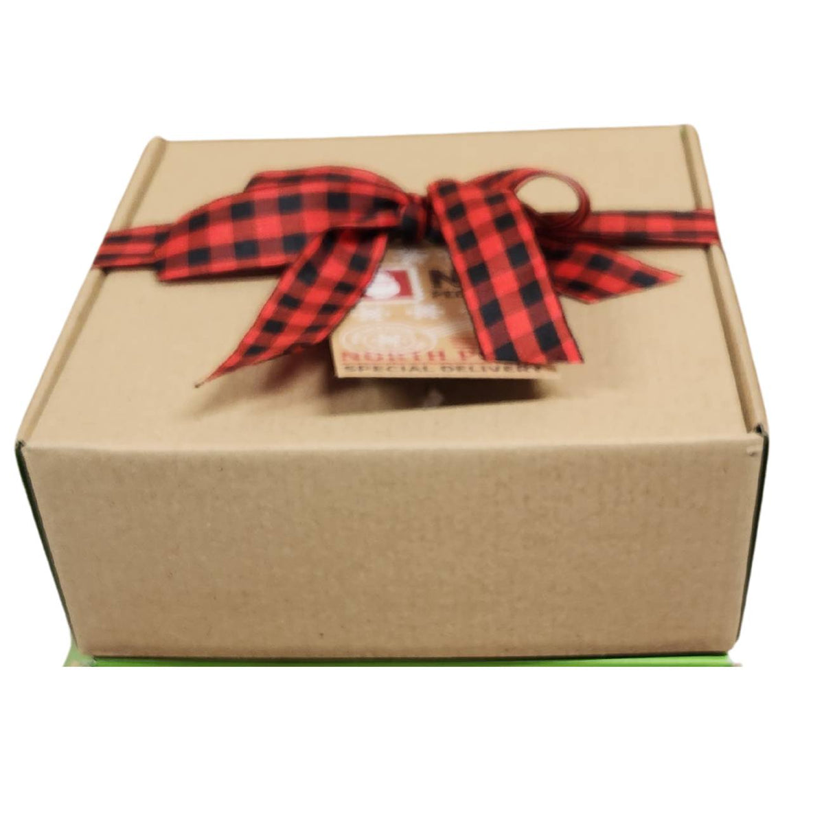 Kraft gift box with a traditional red buffalo plaid bow and gift tag. 
