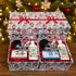 Two open customizable holiday gift boxes displaying the Queen and blue artisan soap gift sets with matching lotions and body jars, sitting below a stacked matching closed box with a red ribbon against a glowing, festive Christmas tree bokeh background.