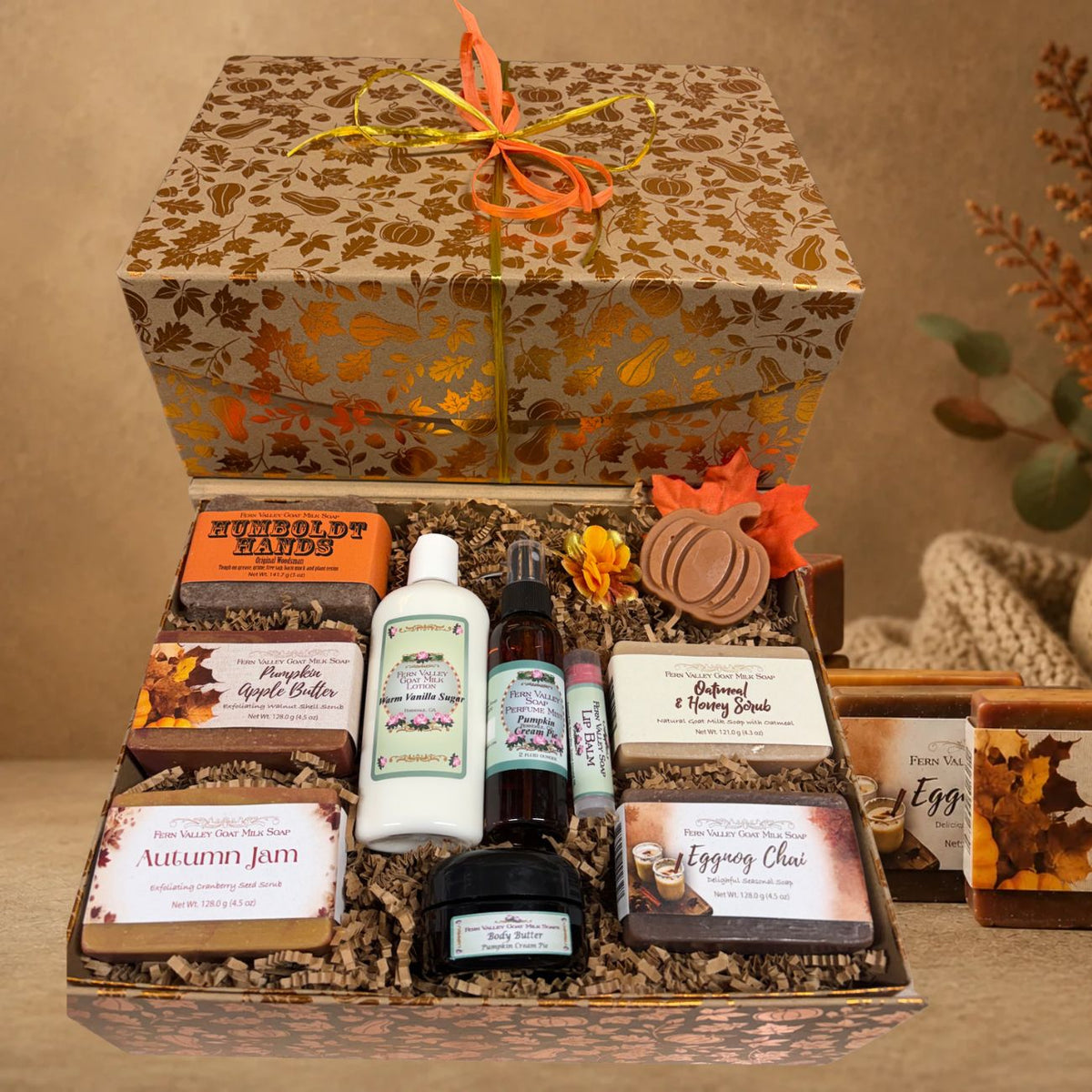 Open autumn harvest gift chest filled with five Fern Valley goat milk soaps, Warm Vanilla Sugar lotion, pumpkin body butter, perfume mist, and a lip balm.