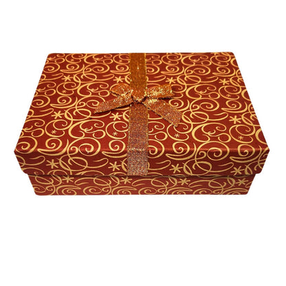 Orange gift box with gold swirl pattern and an orange and gold ribbon on a white background. 