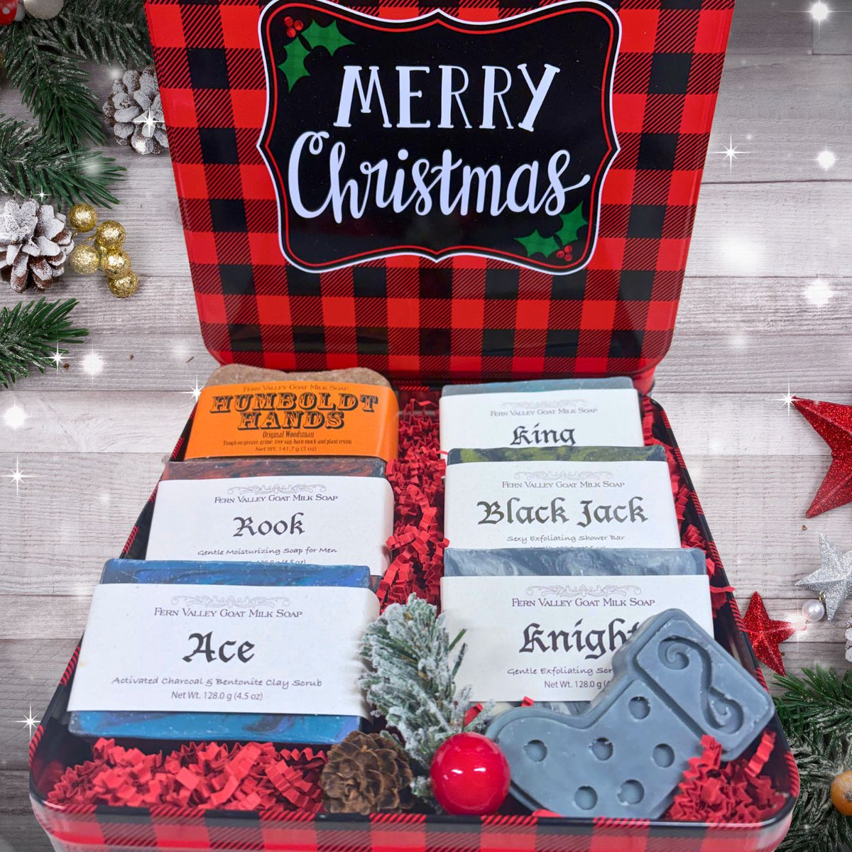 A Christmas-themed gift set in a red and black buffalo plaid tin with a large &