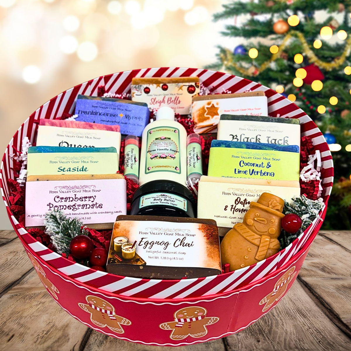 Oversized gingerbread-themed holiday gift tin filled with a colorful arrangement of 13 handcrafted Fern Valley goat milk soaps, body butter, lotion, and an adorable gingerbread man soap.